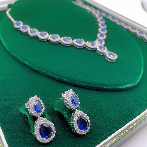 White Gold Finish Blue Sapphire Pear Cut and Created Diamond Necklace, Earring